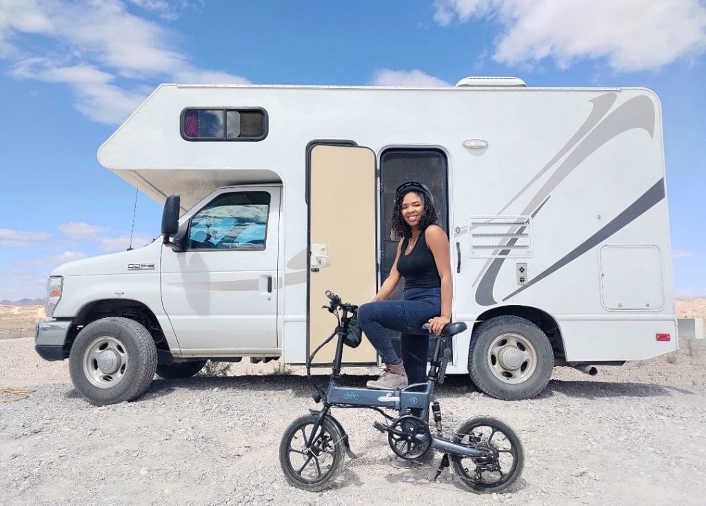 woman on an ebike in front of an RV