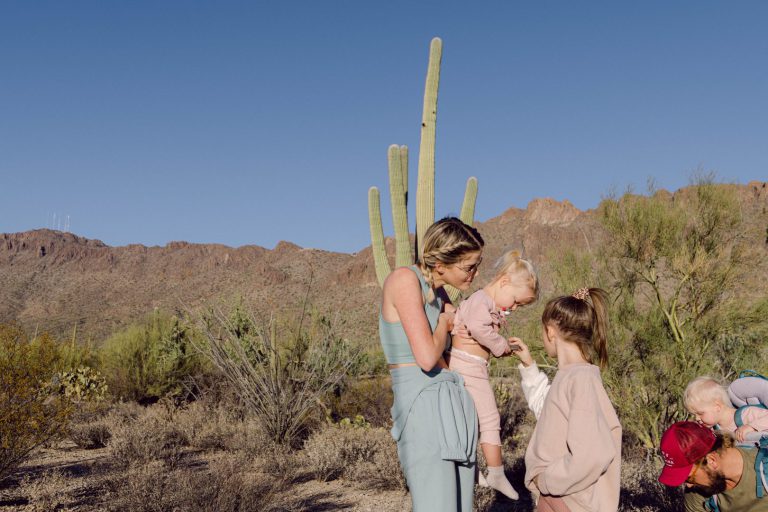 family in the desert in front of a cactus