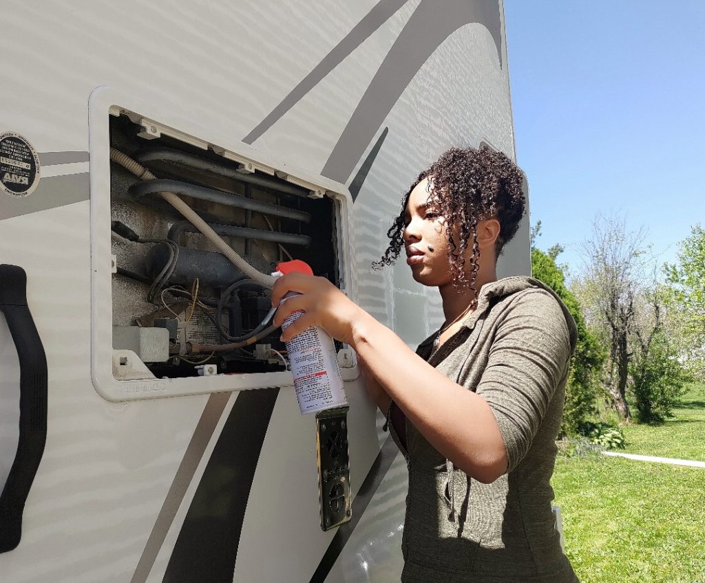 woman cleaning an rv exterior