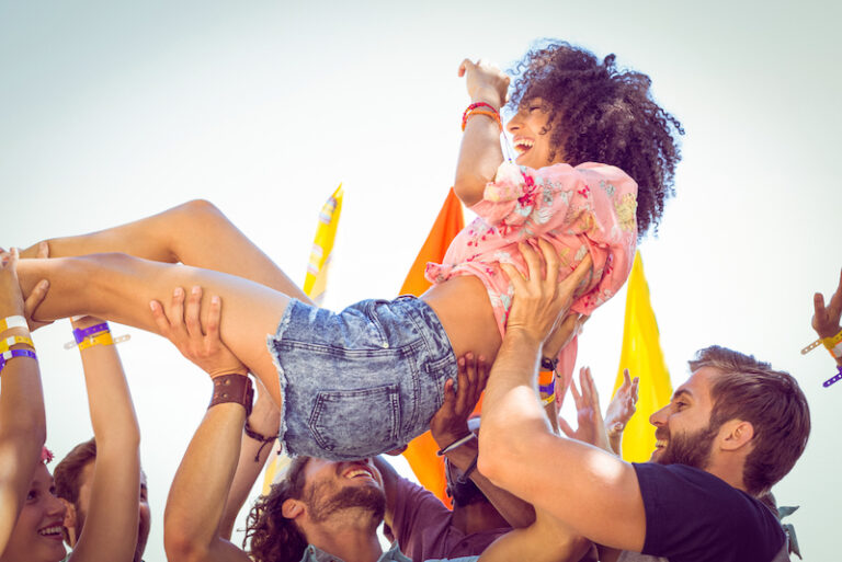hipster woman happily crowd surfs