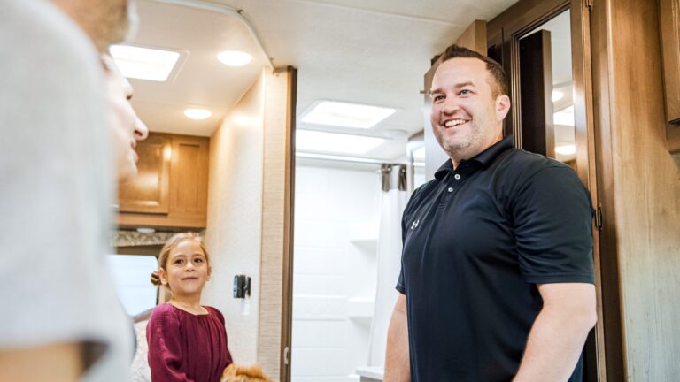 man and girl standing in an RV
