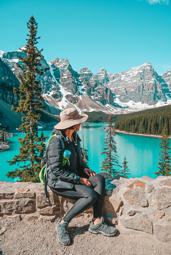 Woman looks towards Morraine Lake in Canada