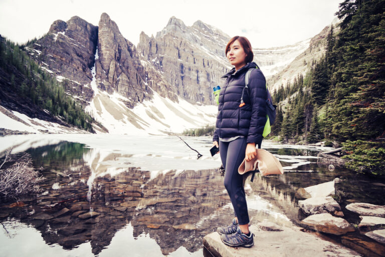 Woman stands mid-hike at Banff National Park