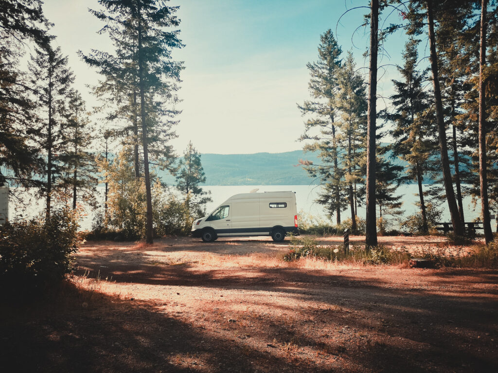 camper van parked in front of okanagan lake in canada