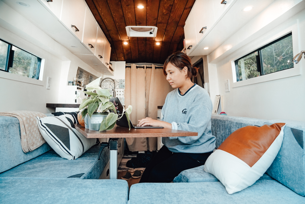 woman working from a table in her rv