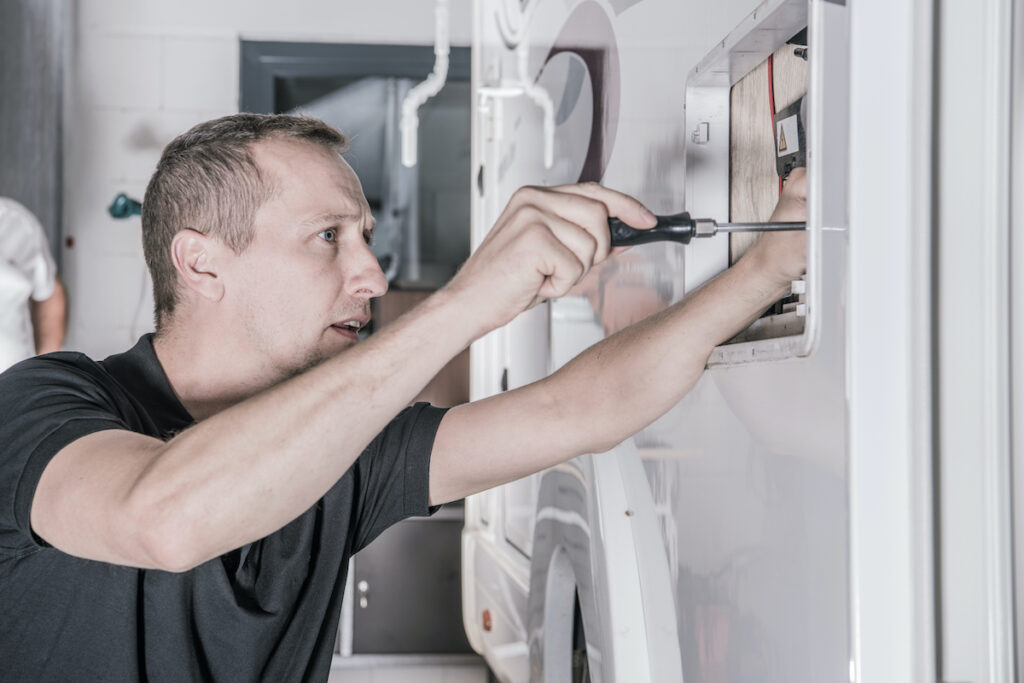 electrician works on RV circuit box