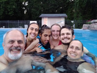 family together in a pool
