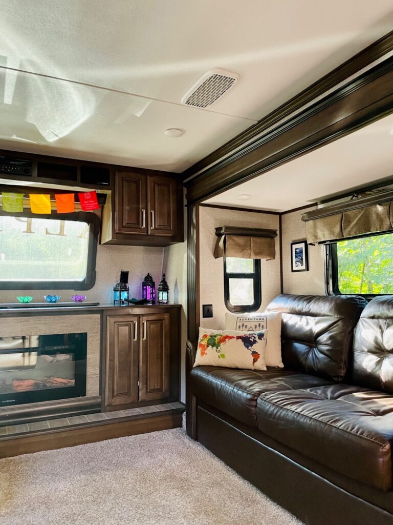 Living room interior of a fifth wheel trailer with colorful decorations