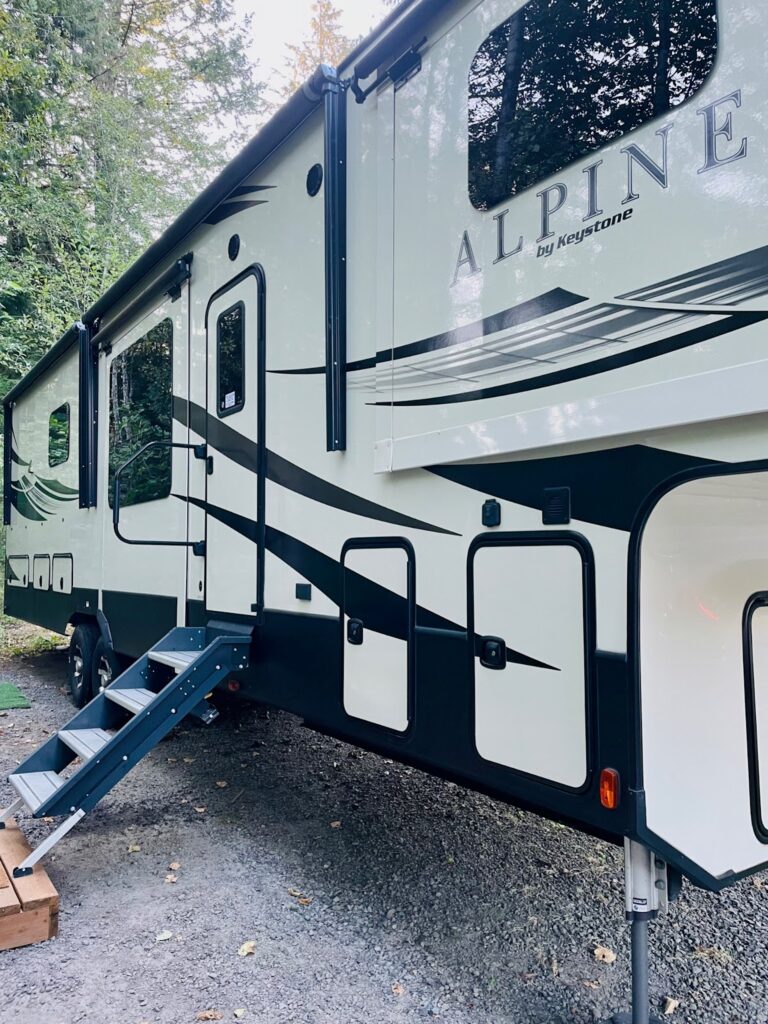 Parked fifth wheel trailer at a campsite