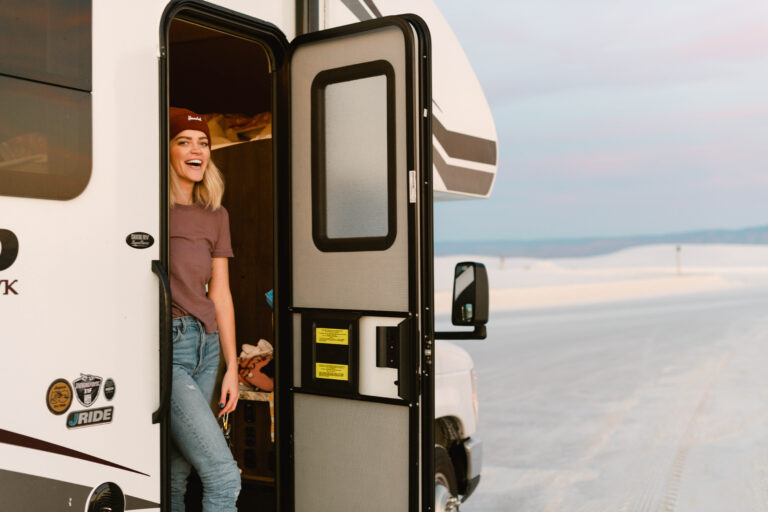 A woman at the door of an RV looking out