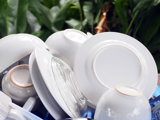 dishes piled up to dry on a drying rack