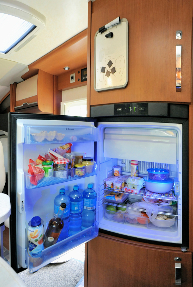 RV fridge open and displaying food inside
