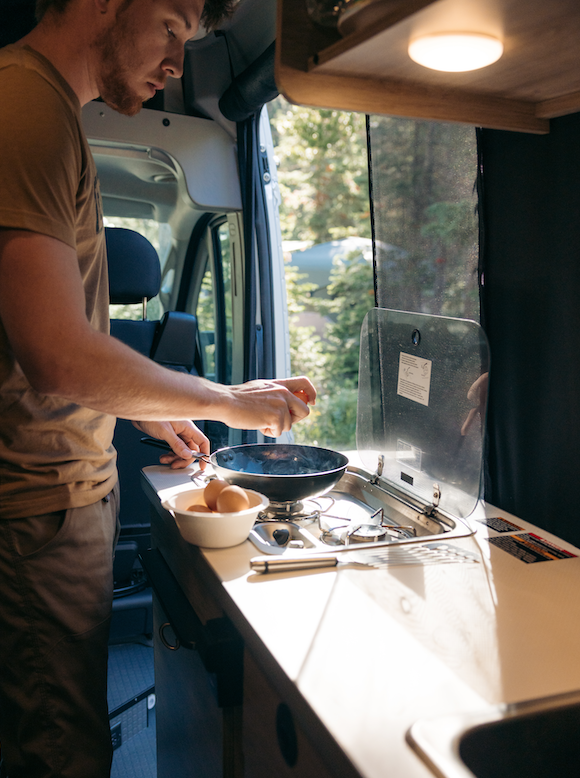 Cooking dinner or lunch in campervan, motorhome or RV. Preparing