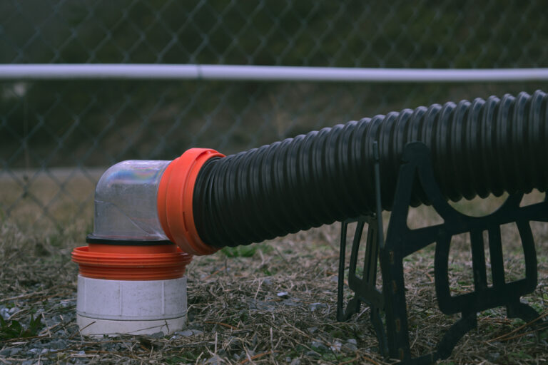 An RV sewer hose connected to the drain
