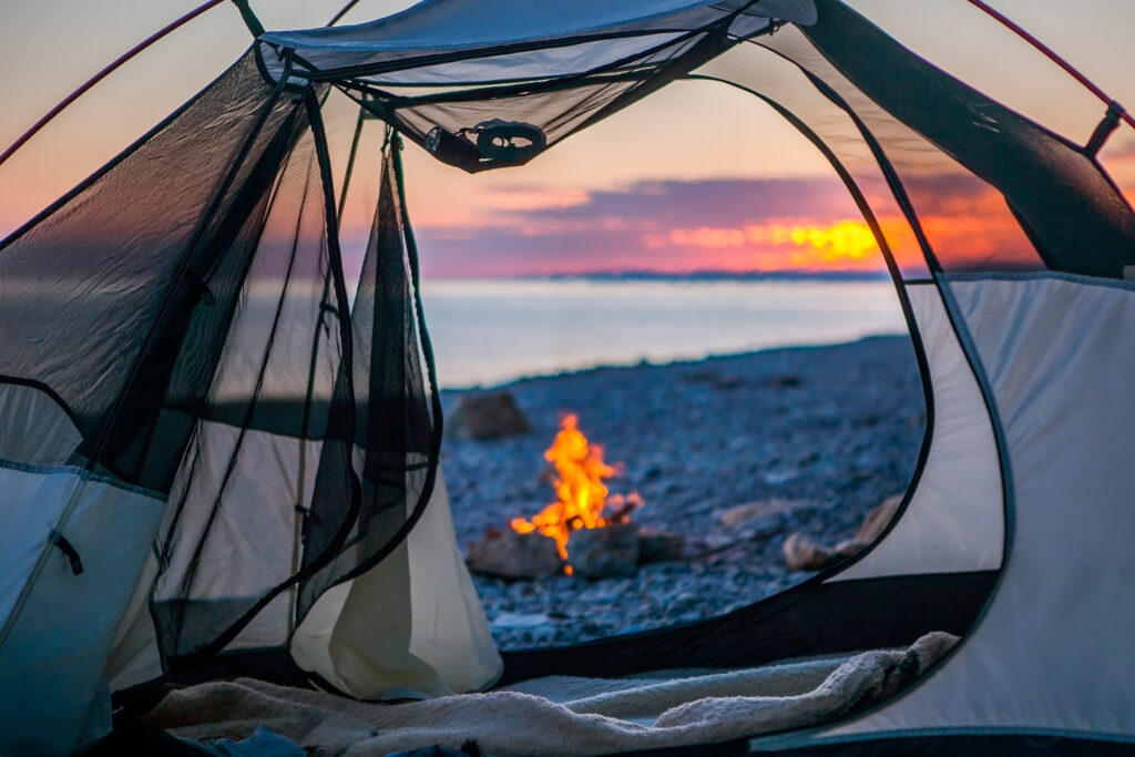 tent with a bonfire outside