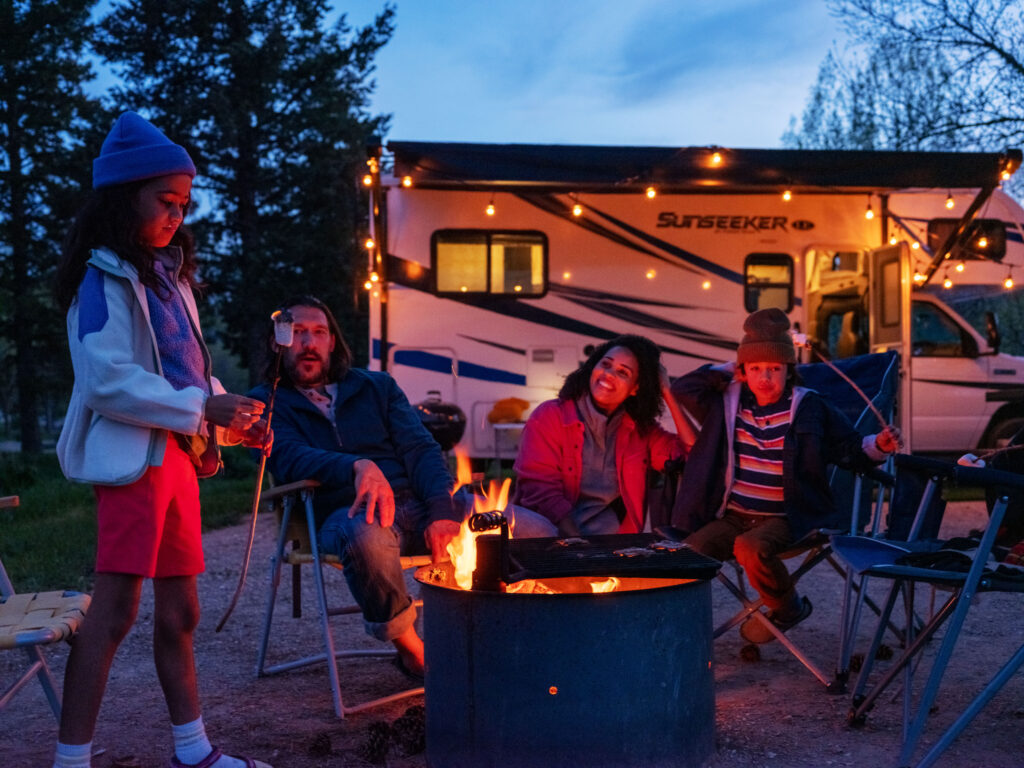 family roasting marshmallows around a campfire
