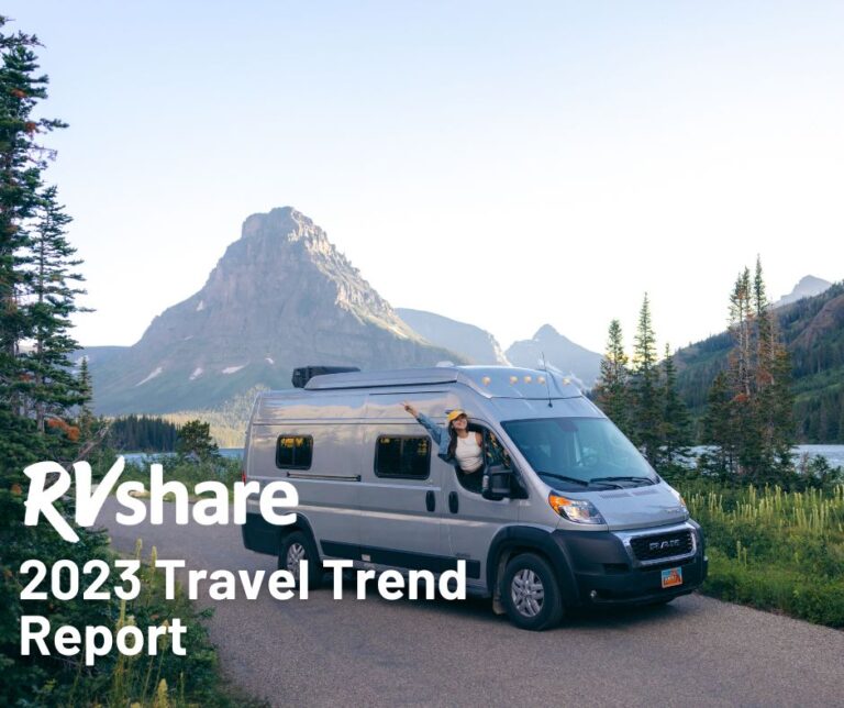 woman hanging out of a camper van with mountain in the distance