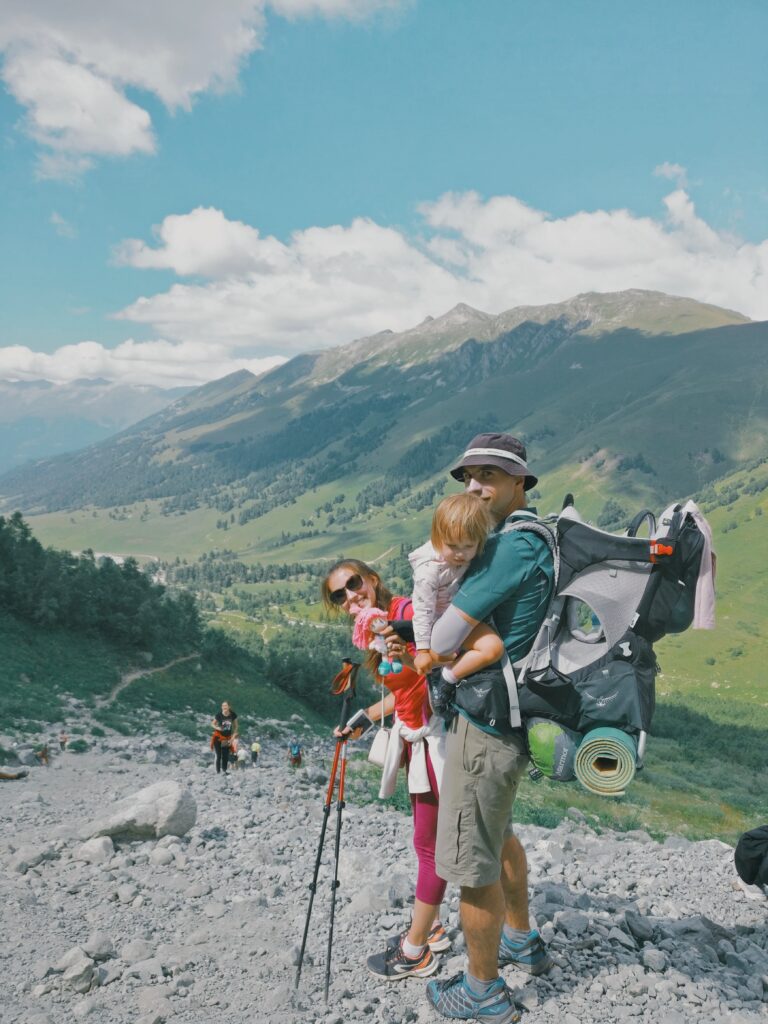 family hiking with baby carrier