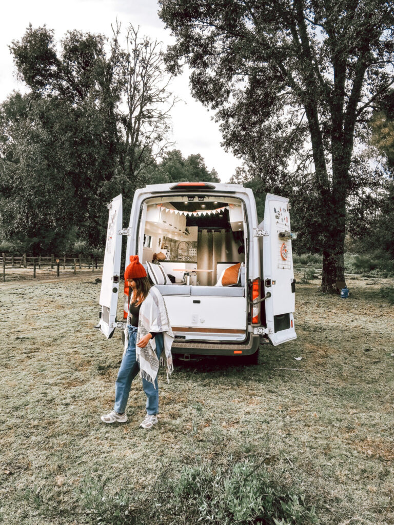 a woman outside a campervan outdoors