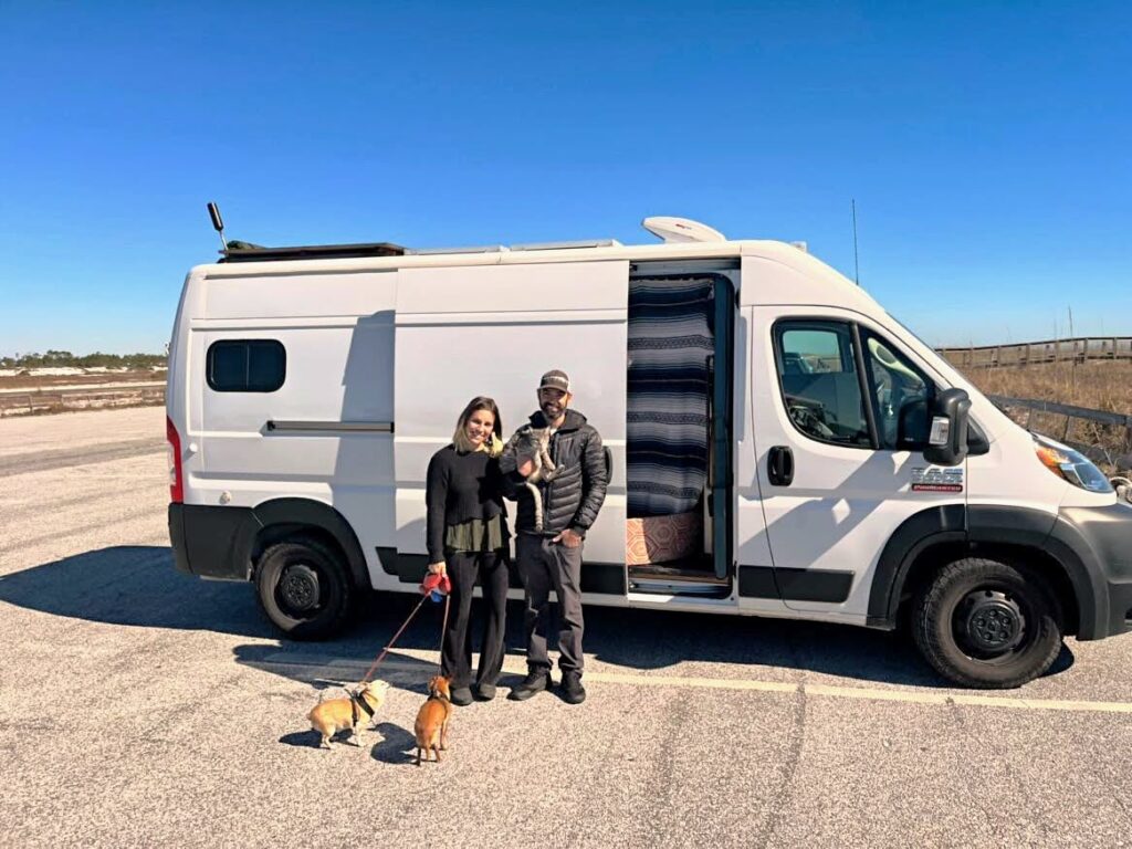 converted van with couple and dogs outside