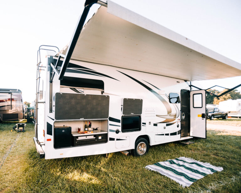 rv set up with awning and outdoor kitchen