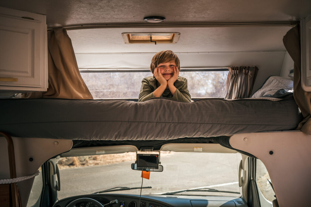 a kid on the over cab bed in a Class C