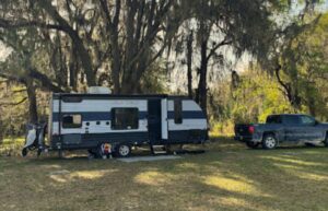 travel trailer set up in camp