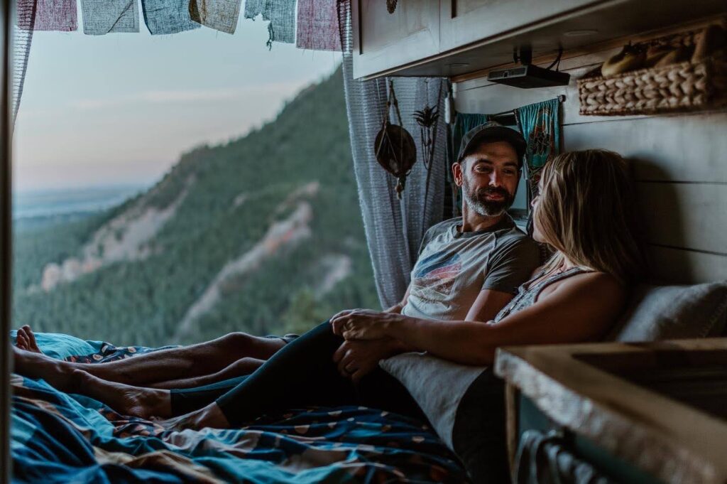 couple inside converted van enjoying a nature view