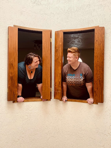 two queer women looking at each other from inside unique accomodation 