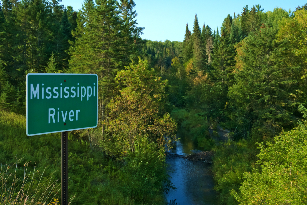 Mississippi River flowing north near its source at Itasca State Park in Minnesota. This sign is at one of the first bridges over the Mississippi River.