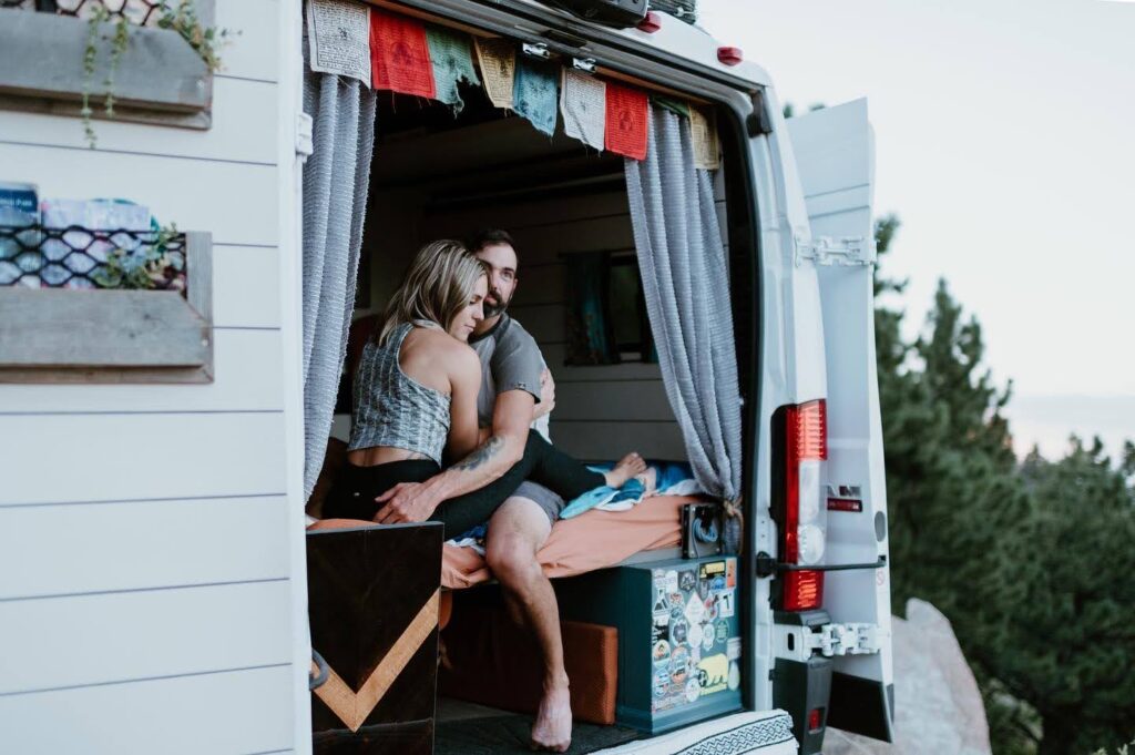 couple sitting in van looking out at the view