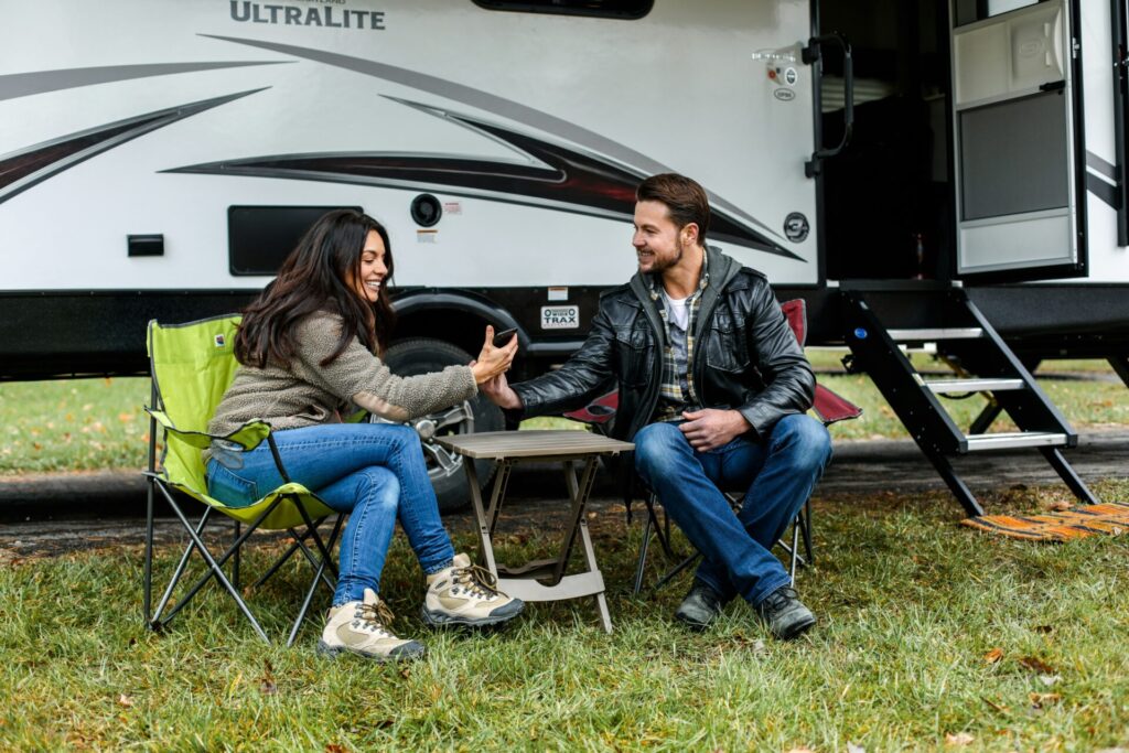 Couple sitting in front of their RV rental delivery