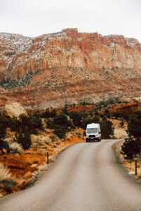 a van driving down a road in Canyonlands