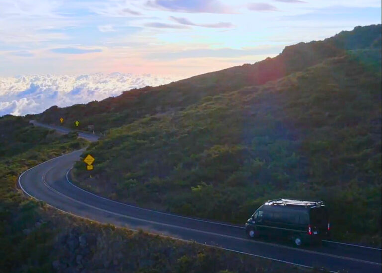 van driving a road in Maui