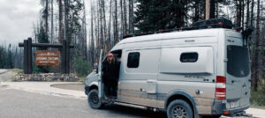 van at grand tetons national park with woman standing outside the door