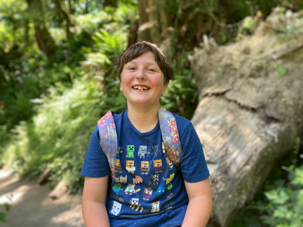 Boy smiling at camera while camping in Washington