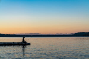 Woman Fishing Lake Tahoe During Sunset