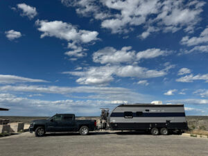 travel trailer RV with truck at rest stop