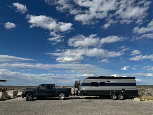 travel trailer RV with truck at rest stop